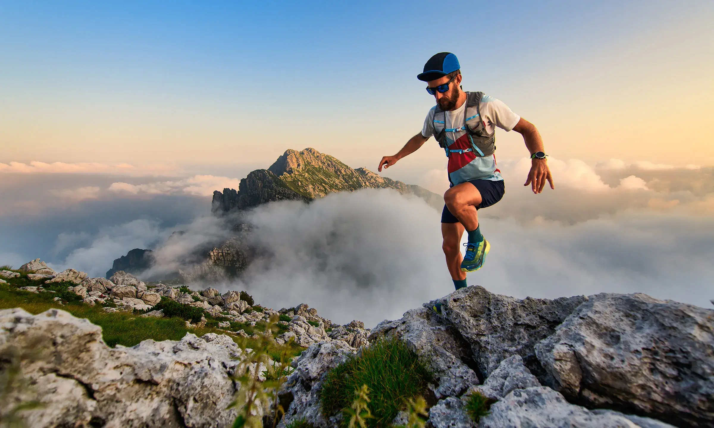 Homme pratiquant le trail en montagne dans un paysage alpin grandiose